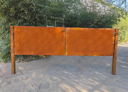 Rust-finished metal garden gate with wing design